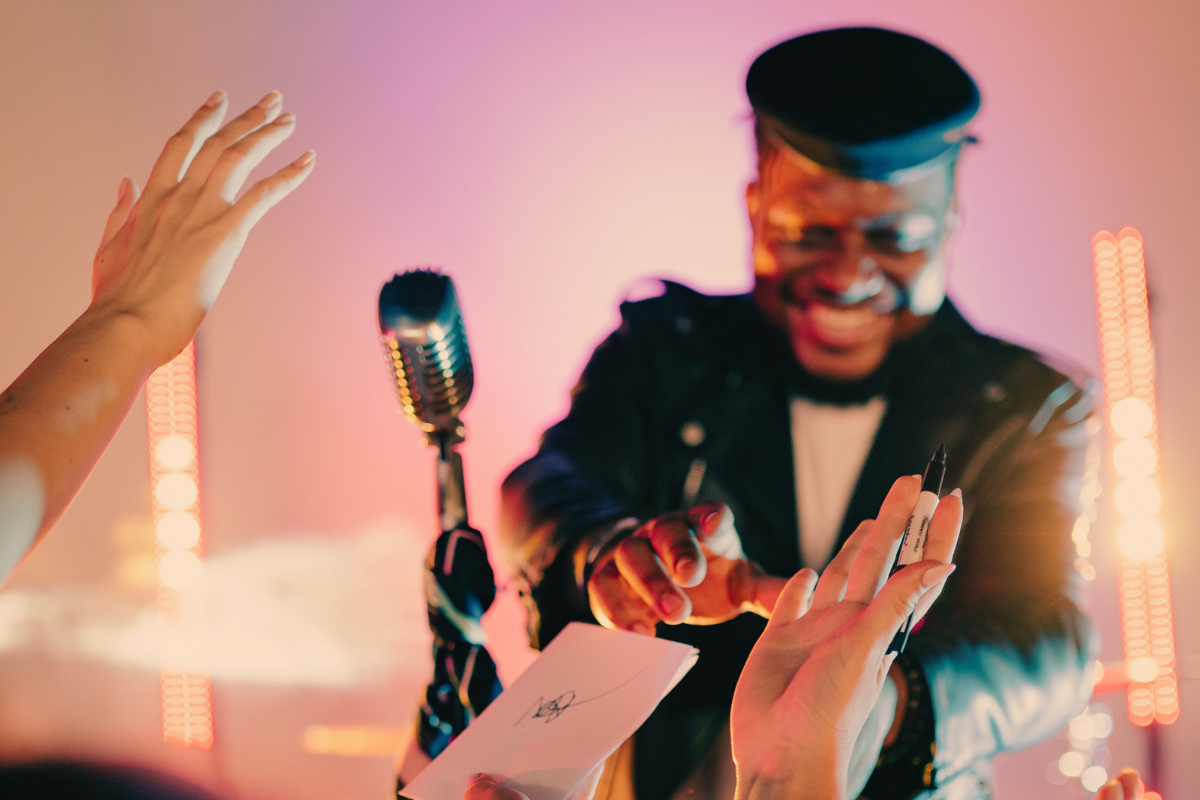 Performer signing autographs at a gig