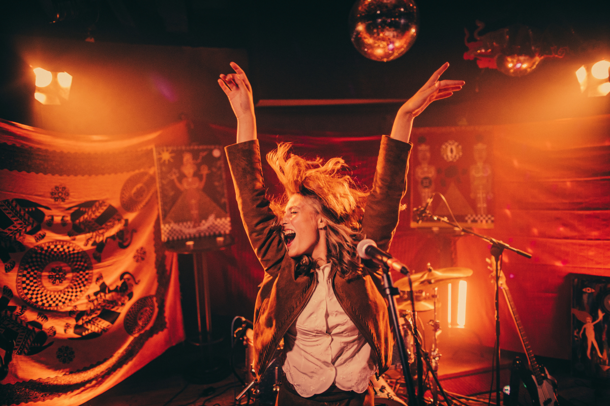 Female singer dancing energetically on stage